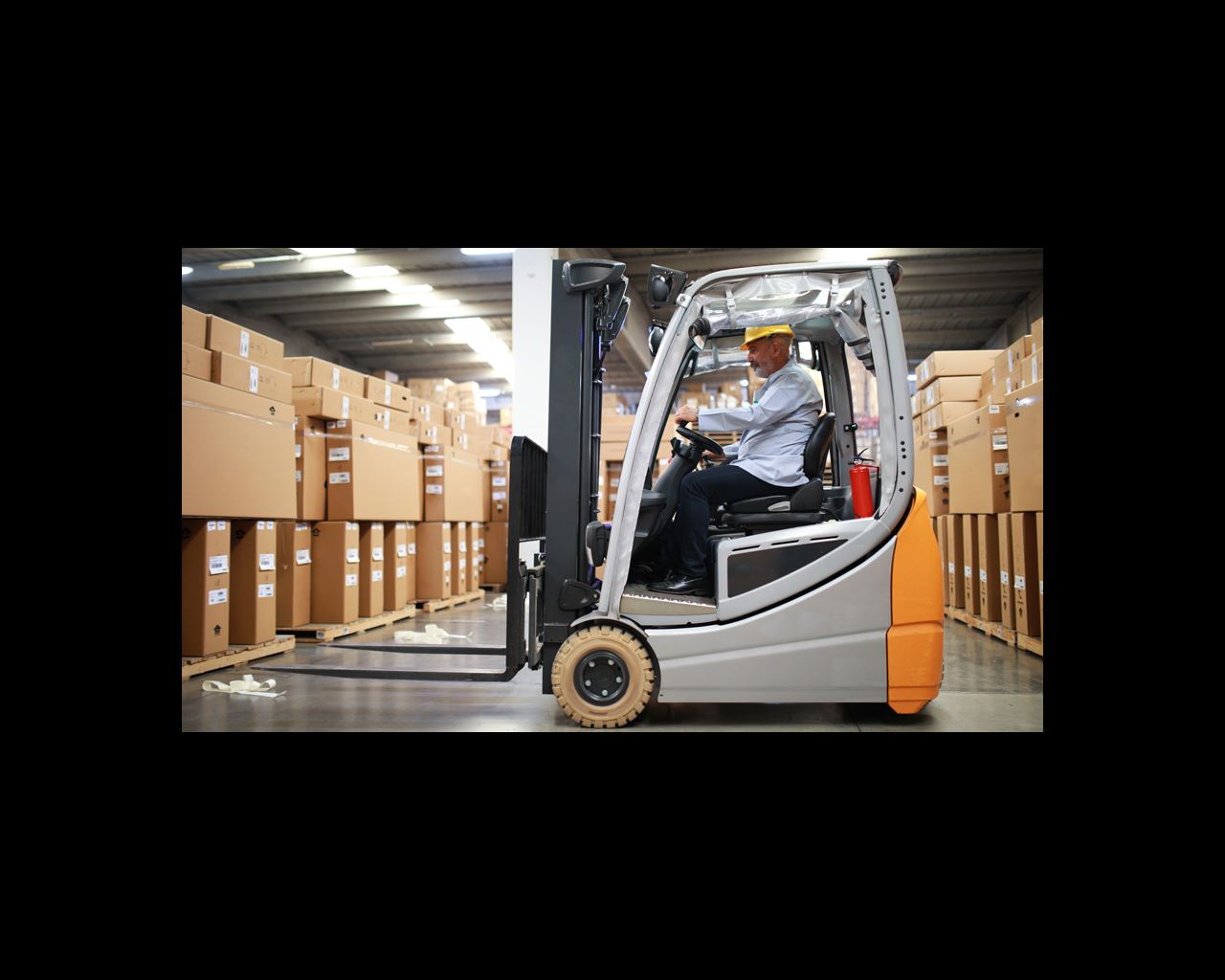Man in warehouse operating a forklift