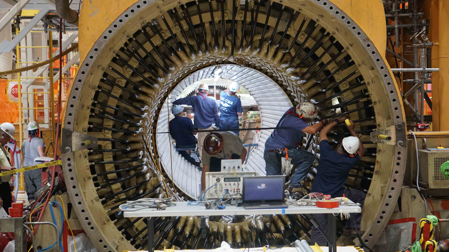 APS employees working on a generator