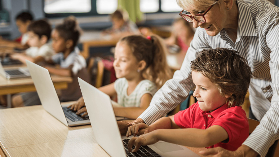 Kids using a computer and following directions from teacher.