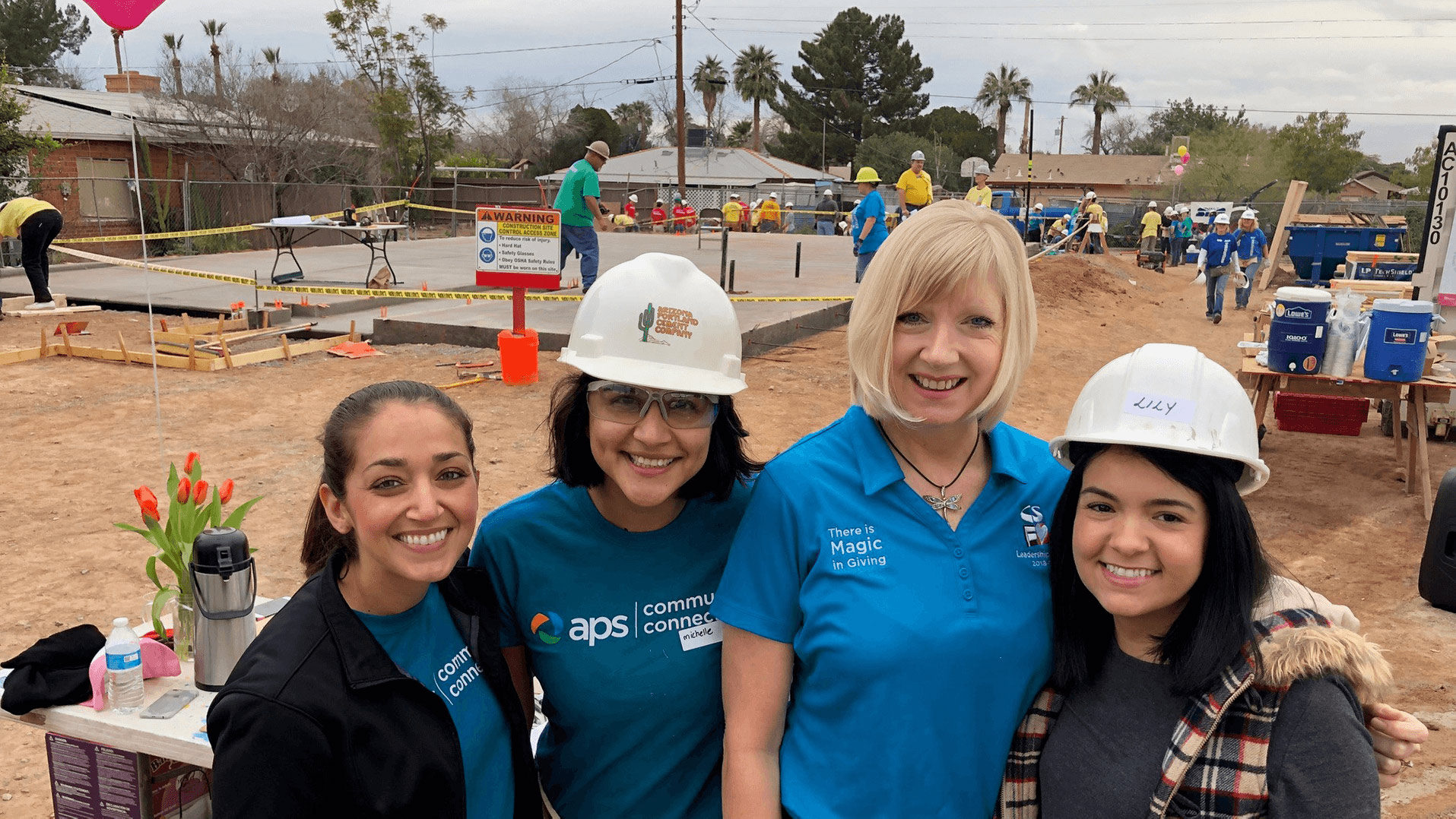 APS volunteers smiling at an event.