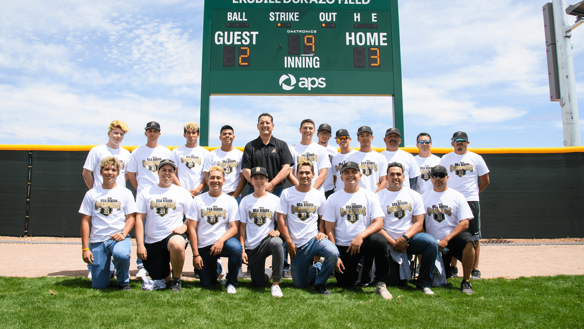 Baseball team portrait in front of the scoreboard.