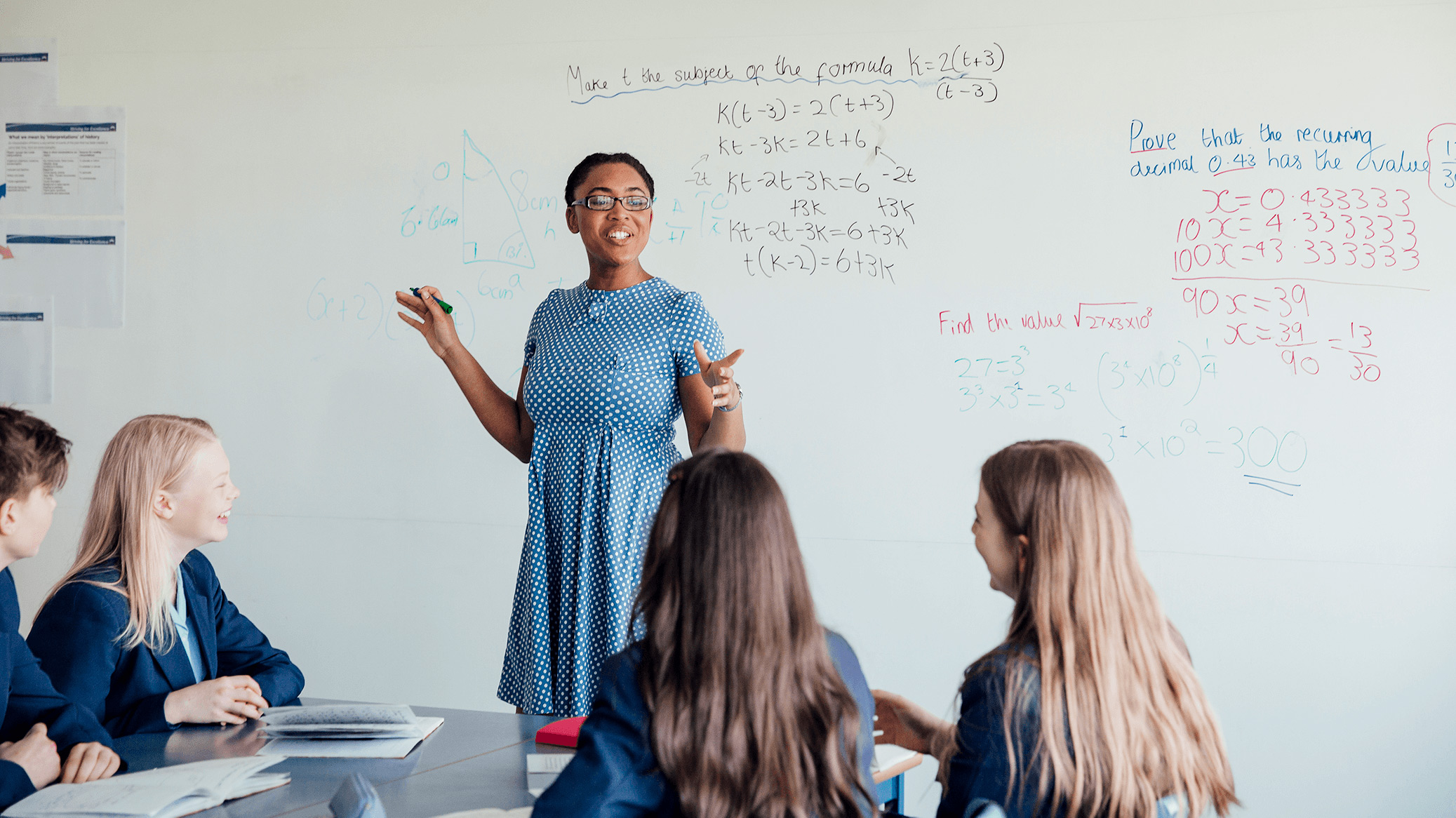 Math teacher smiling and talking to her class.