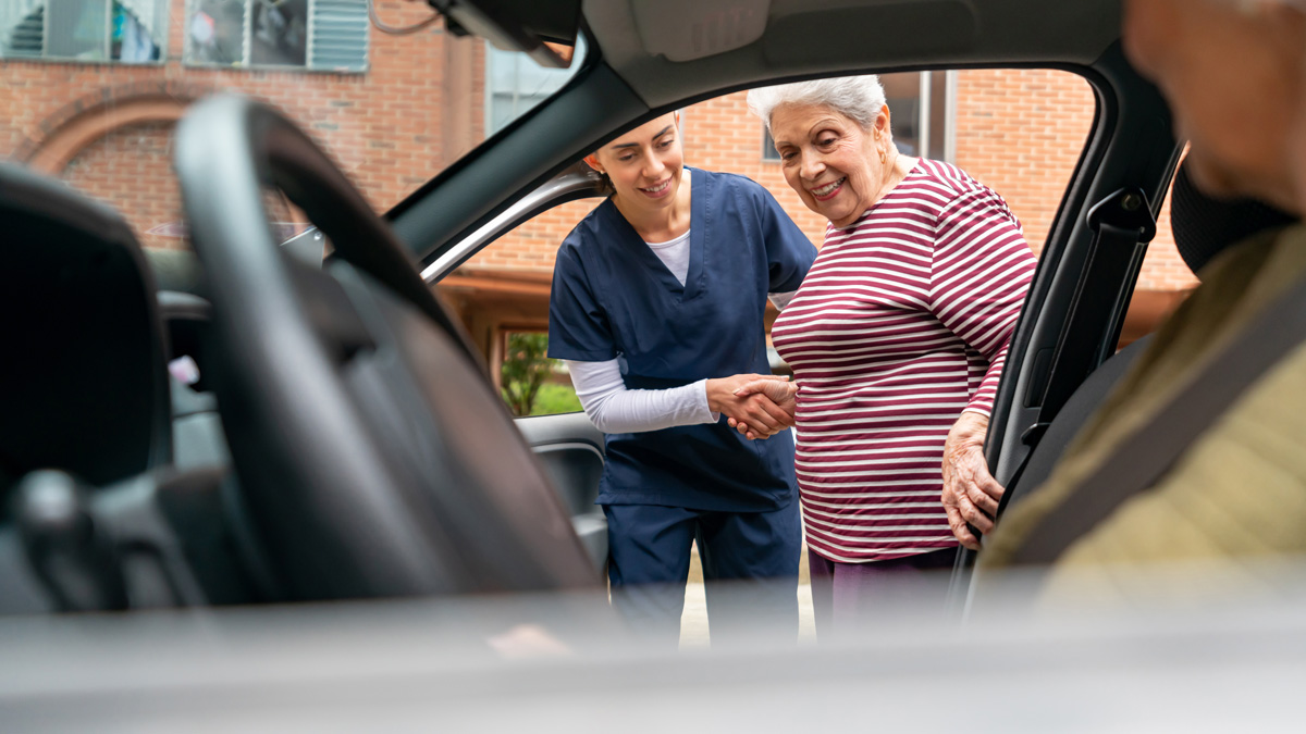Woman being helped into a car