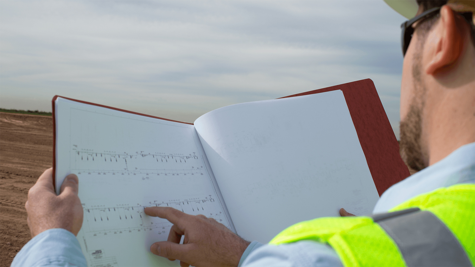 Construction professional looking at blueprints.