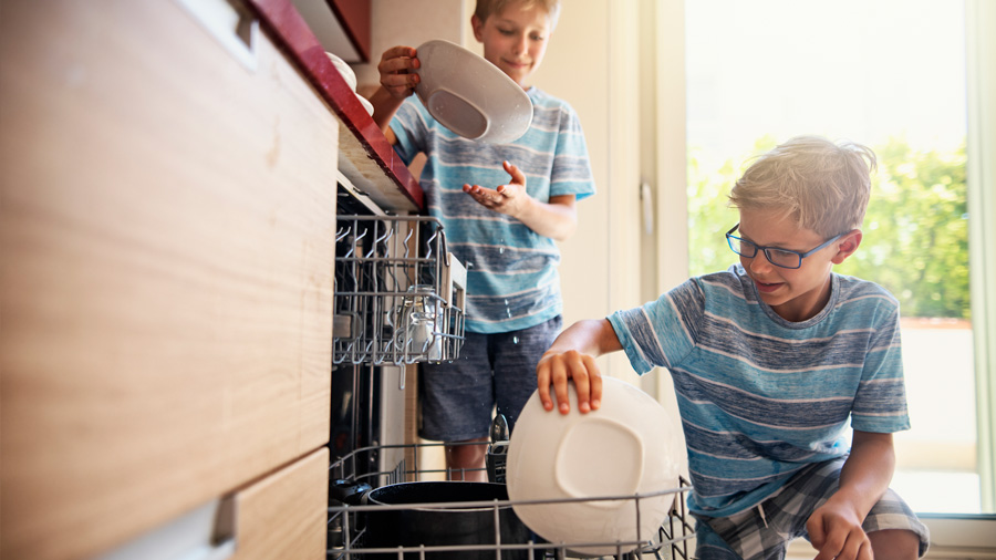 Boys loading the dishwasher