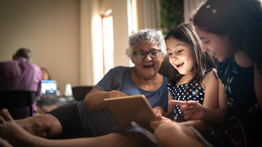 Family on the couch using a tablet