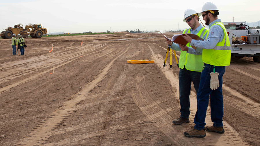 Two APS workers discussing project at a construction site