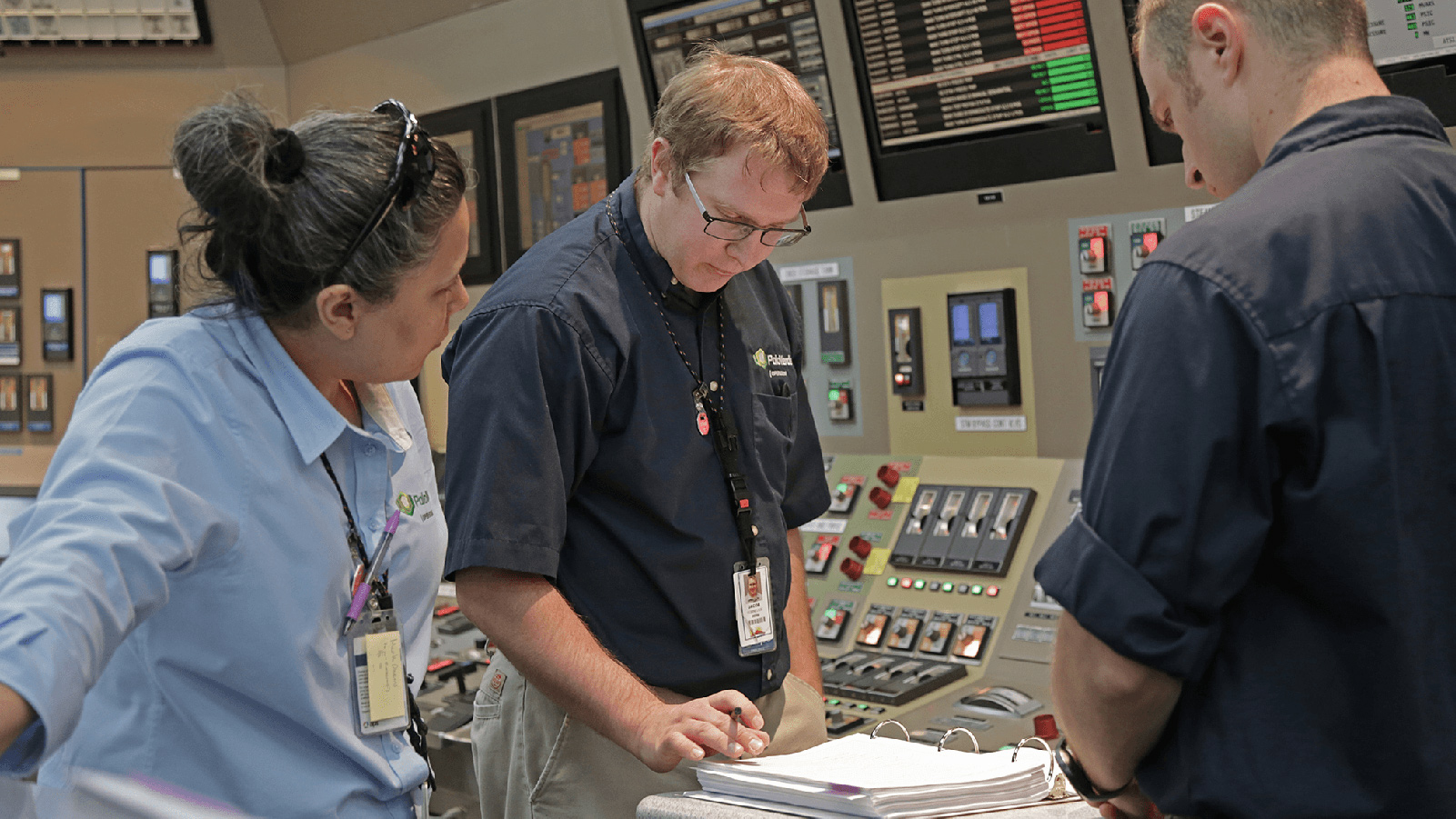 Three employees operating computer system