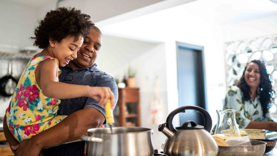 Family cooking together in kitchen