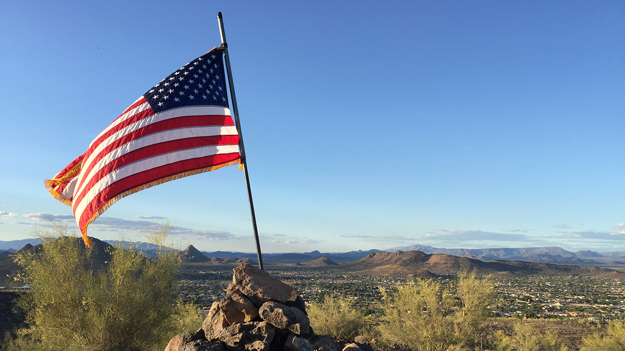 American Flag flying in Phoenix Desert scenery.