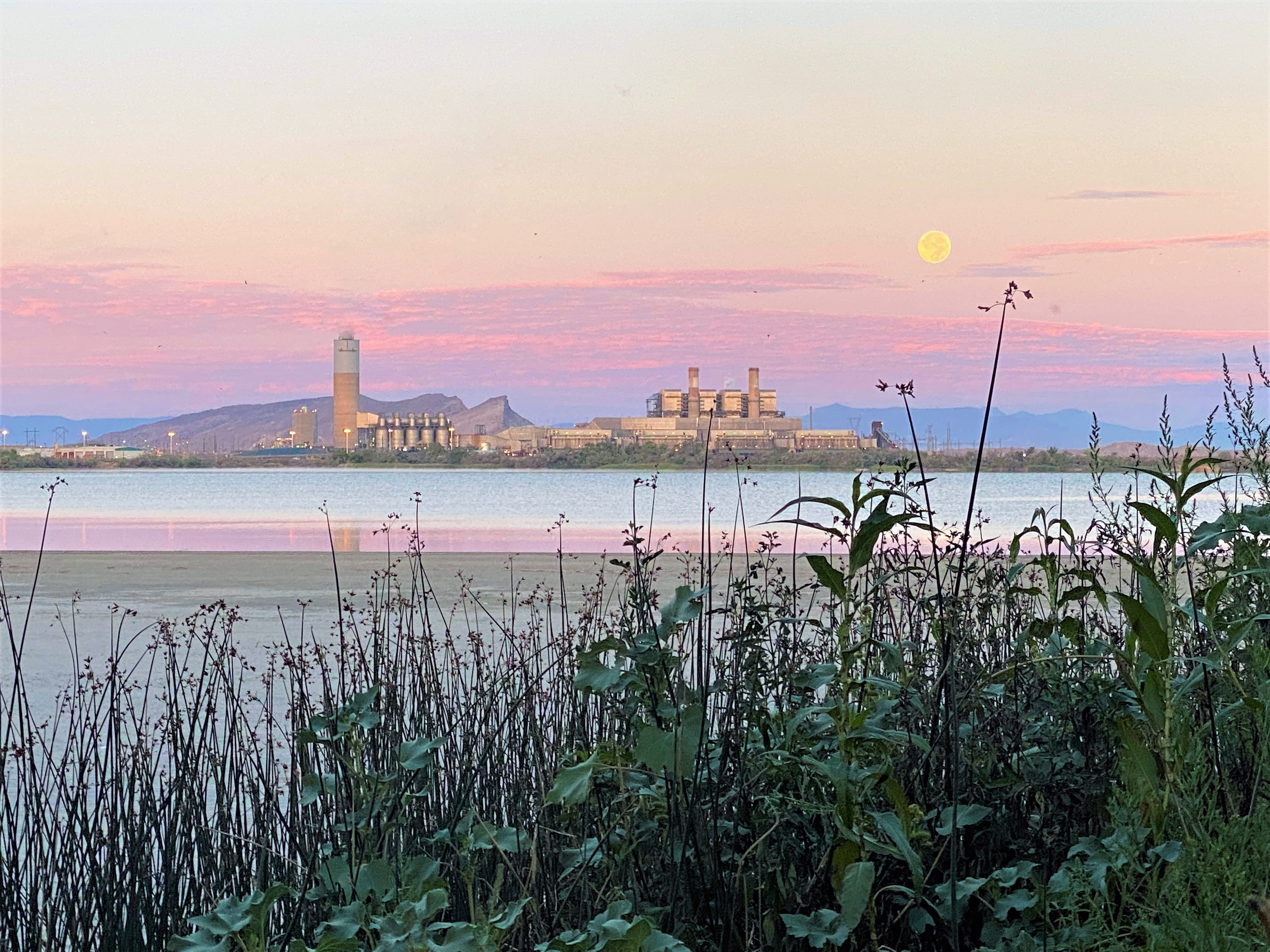 Central eléctrica a lo lejos, al otro lado del lago