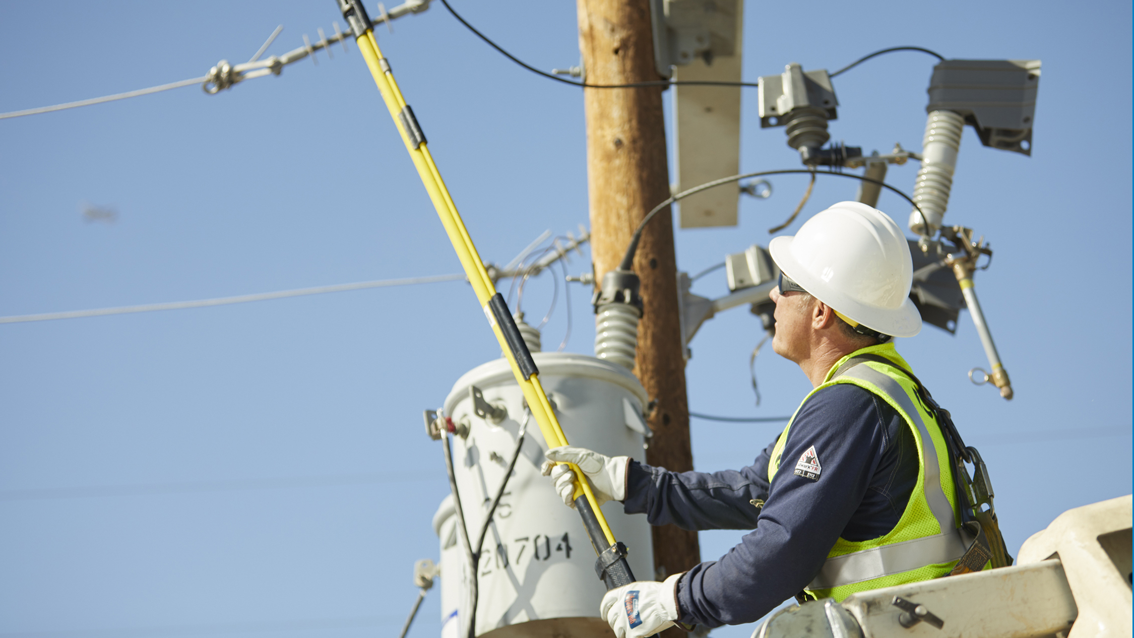 An APS lineman on a power pole