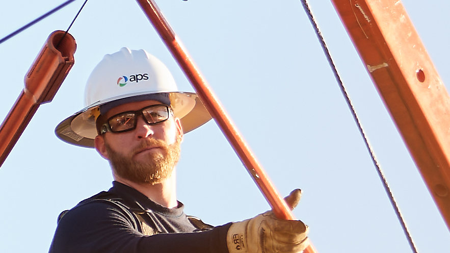 APS Employee working on a line