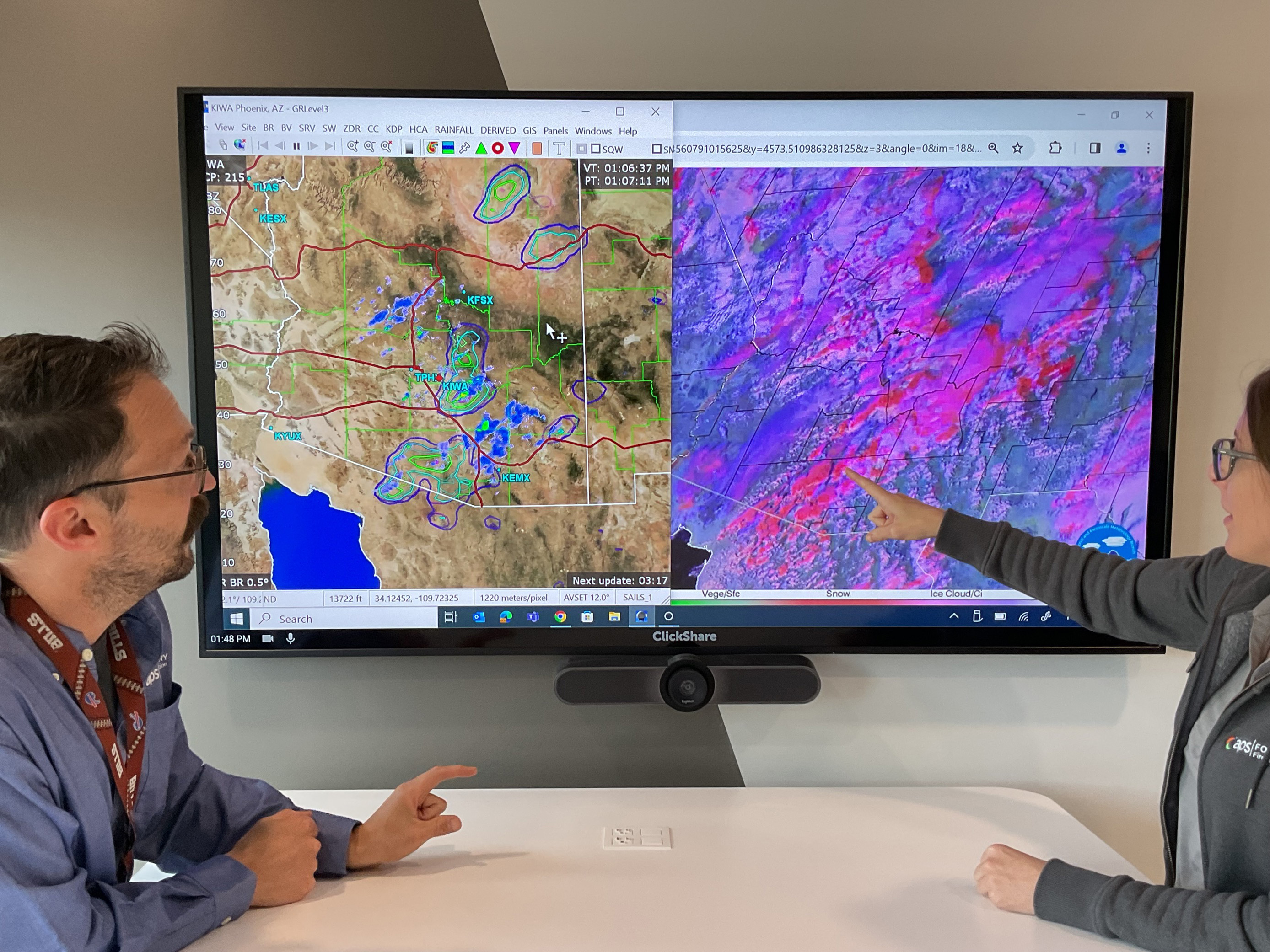 APS meteorologists at a screen monitoring weather patterns