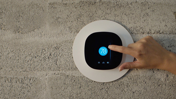 A hand adjusting an Ecobee Smart thermostat