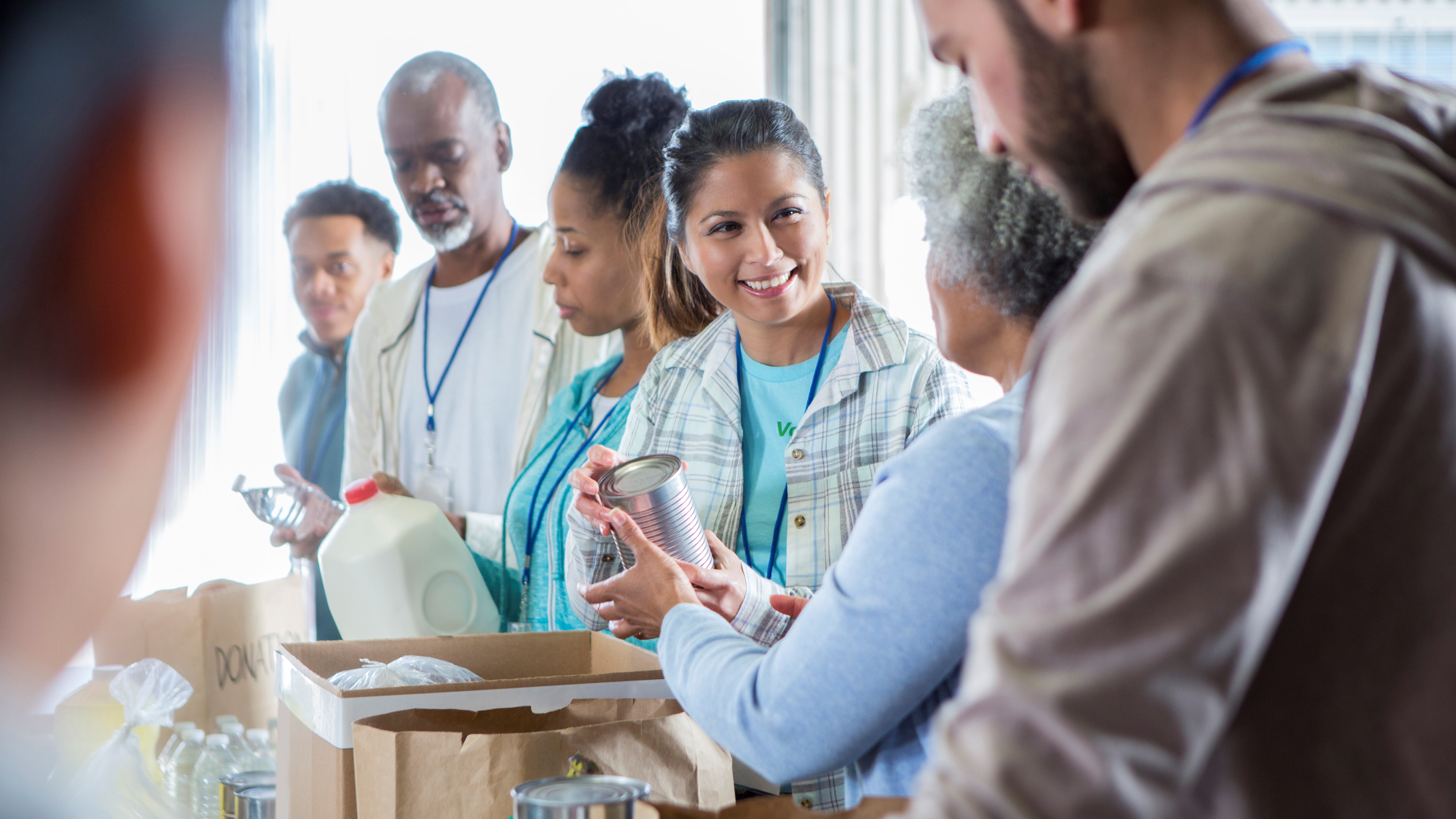 people helping bag groceries at a foodbank