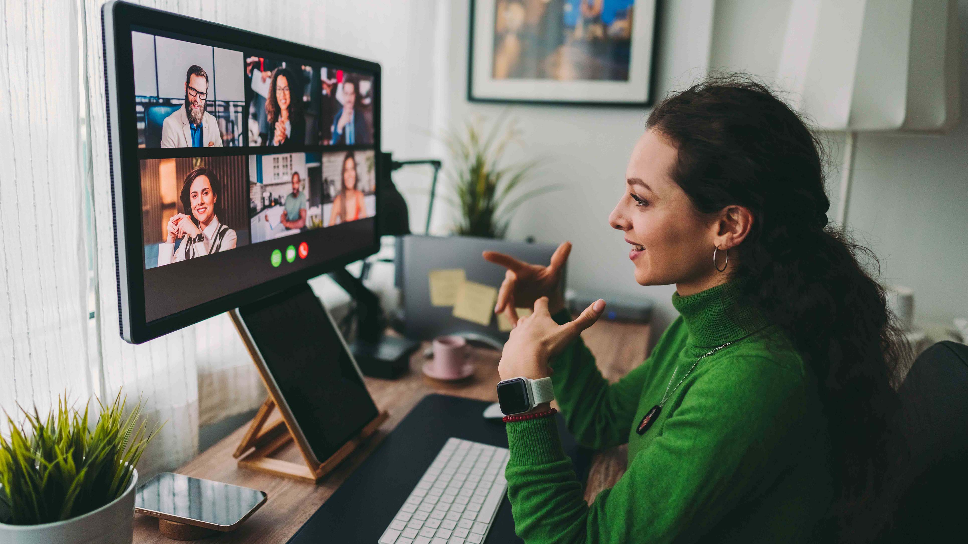 Individual sitting at a desk on a video call.