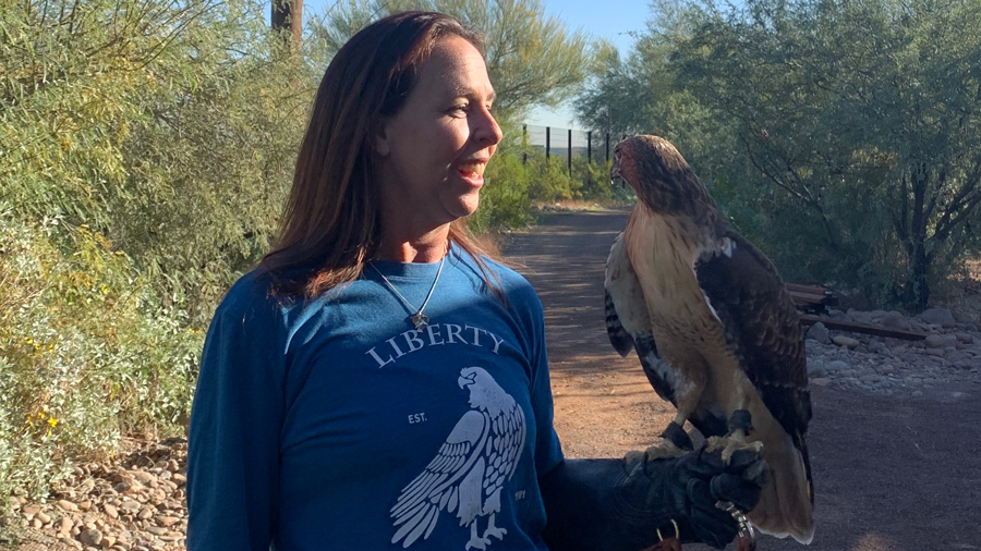 Liberty Wildlife Biologist Laura Hackett holds a hawk