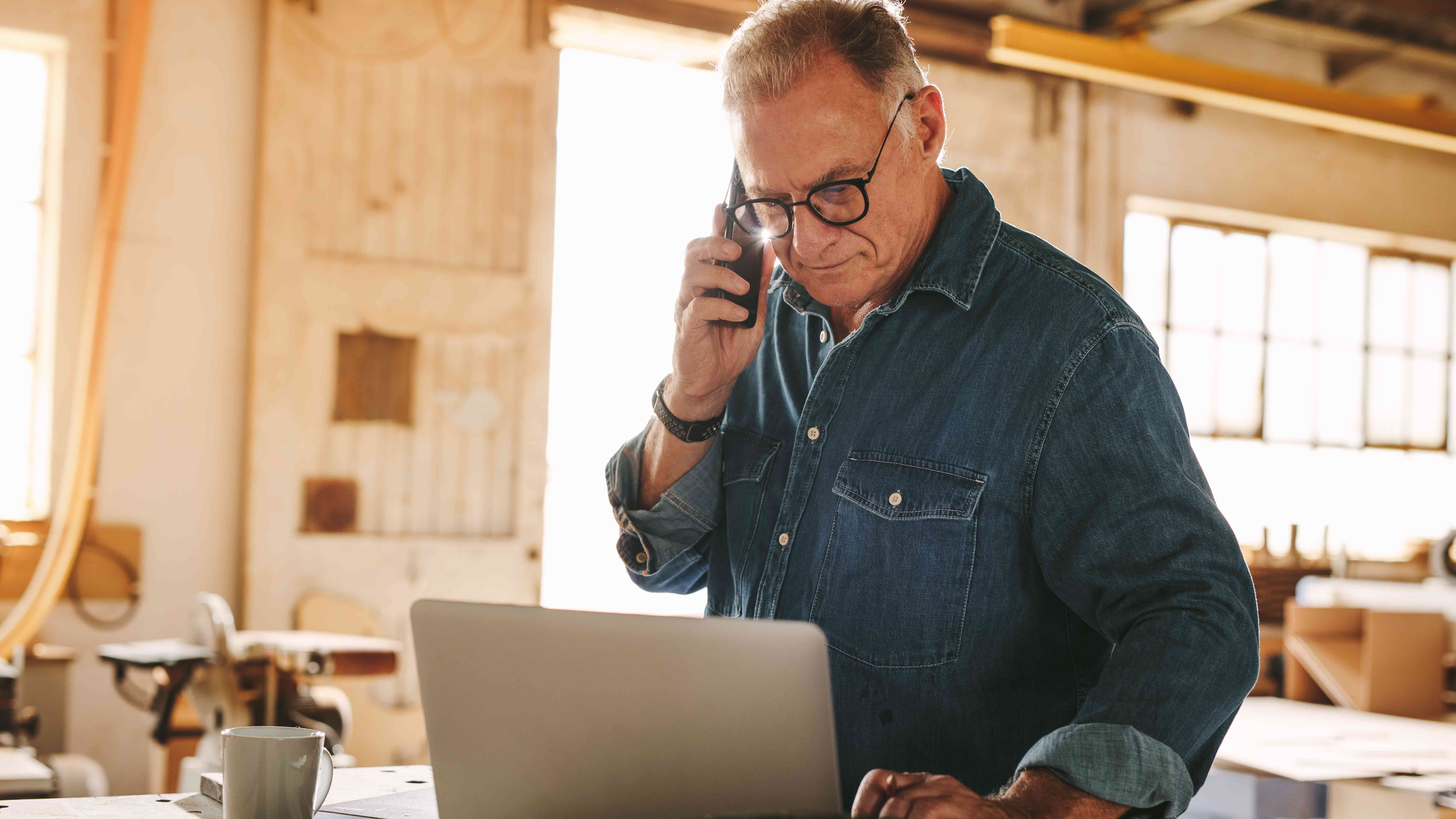 Man talking on a phone at an office