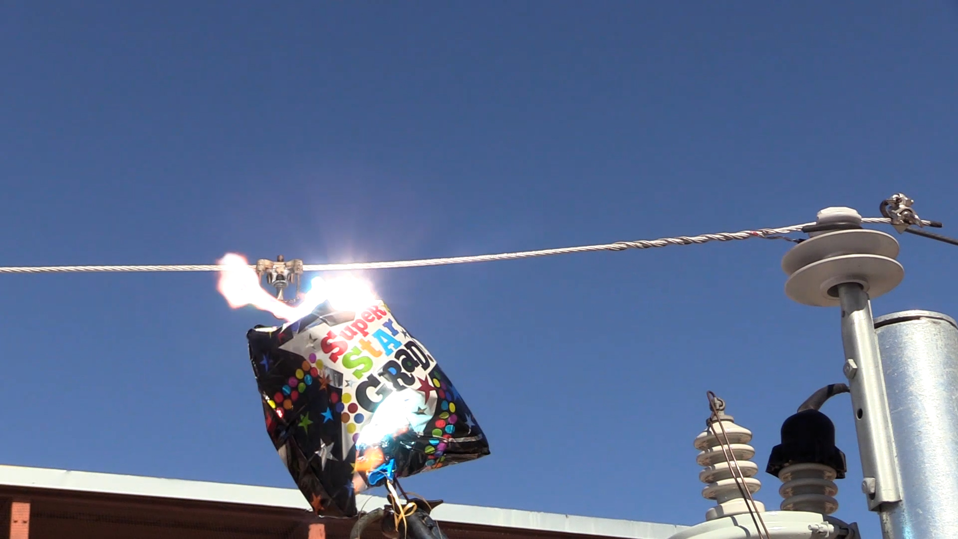 A Mylar balloon in contact with a power line igniting a spark 