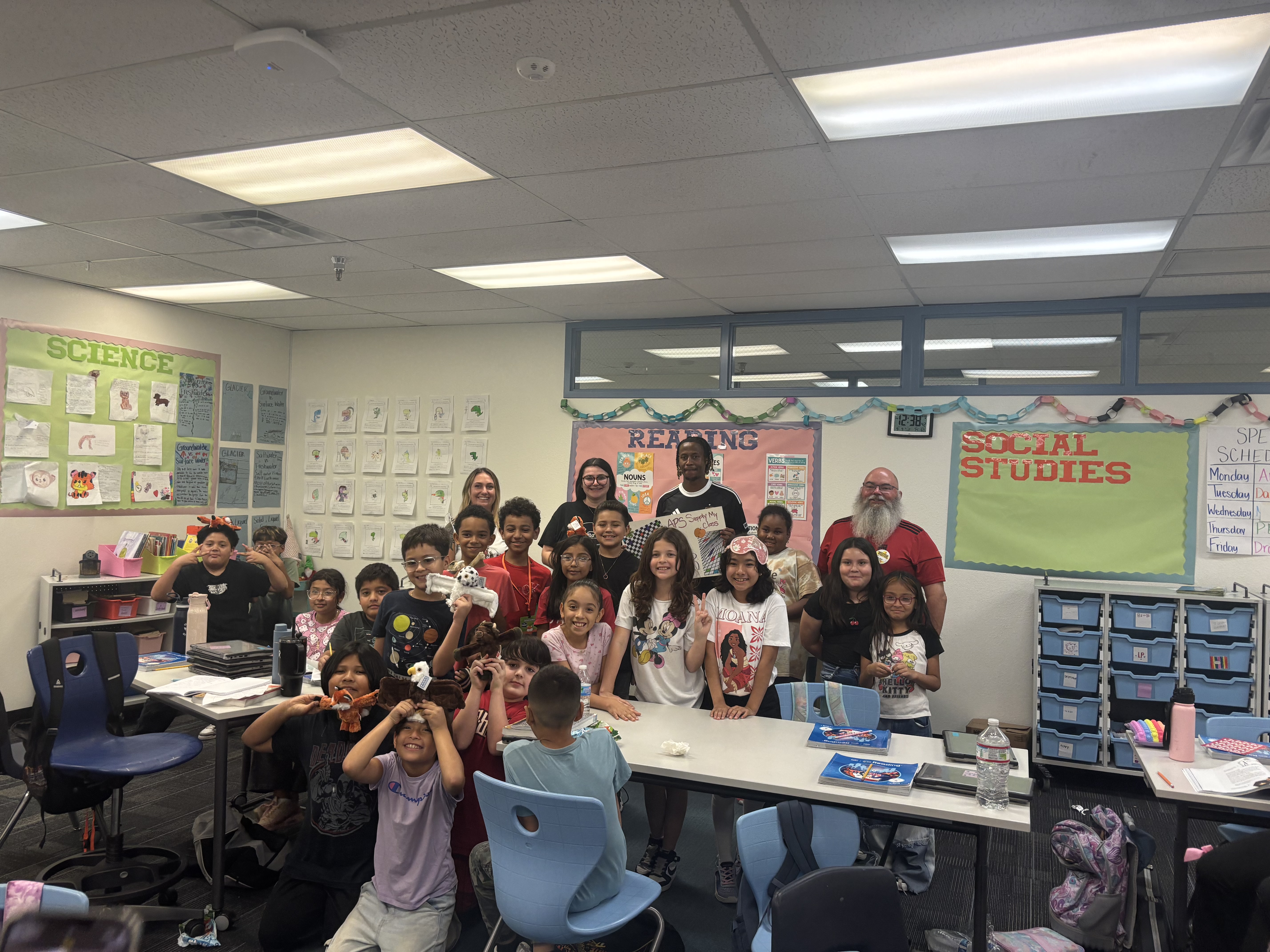 Phoenix Rising Forward Remi Cabral and APS Energy Innovation Advisor Trevor Swanson surprised teacher Ms. Flower at Silvestre Herrera Elementary School in Phoenix