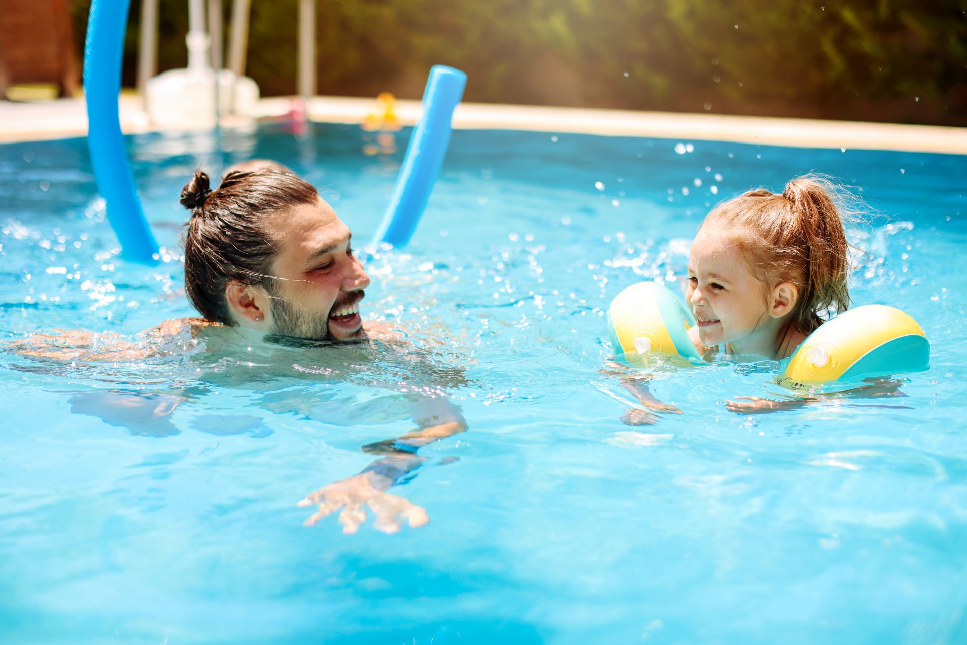Father and daughter in the pool