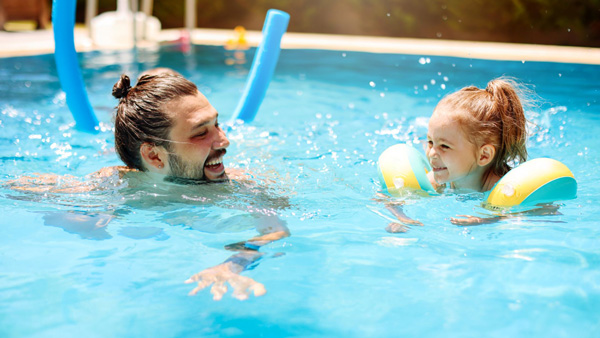 Father and daughter in the pool