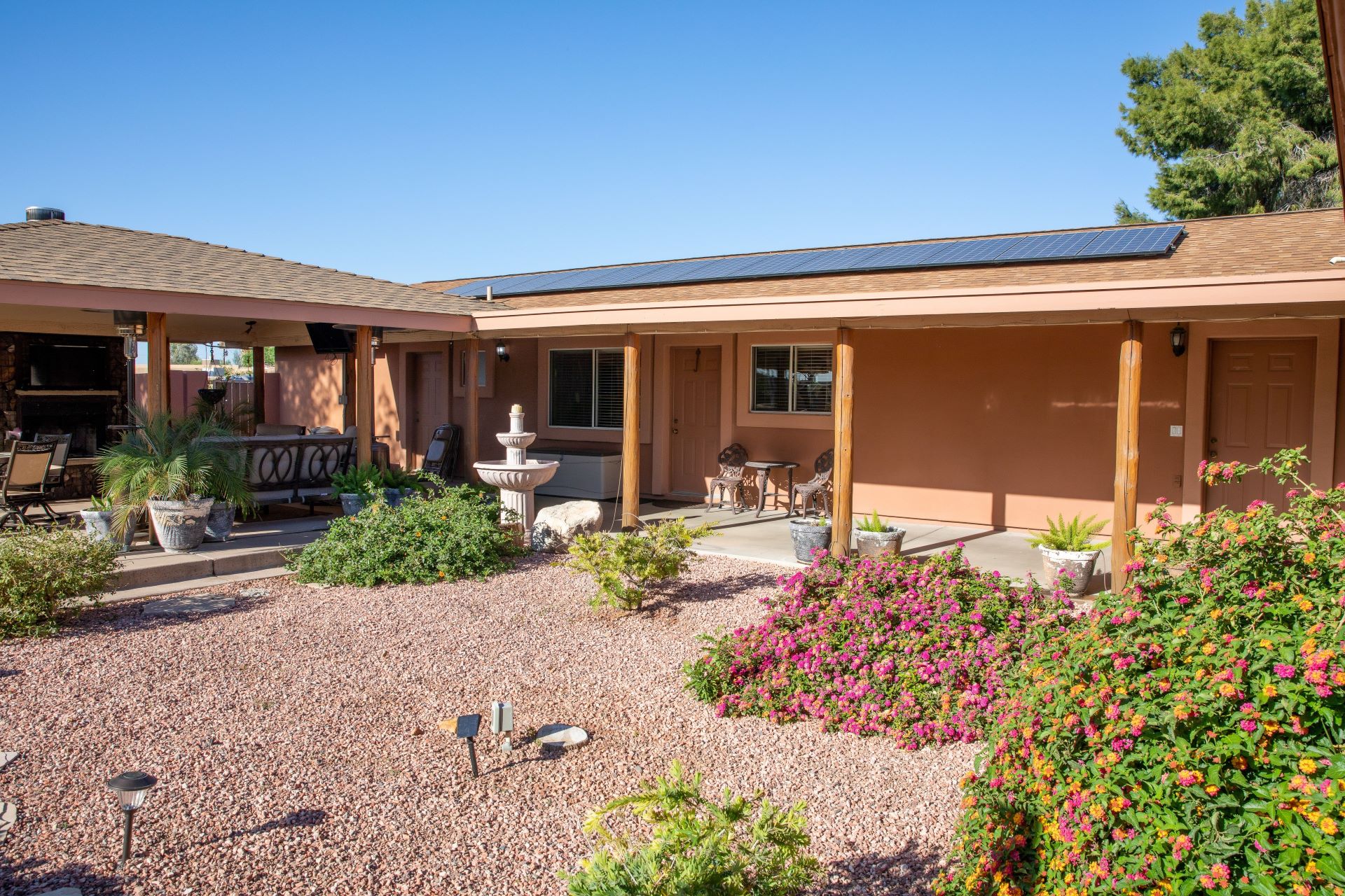ranch style home with solar panels on the roof