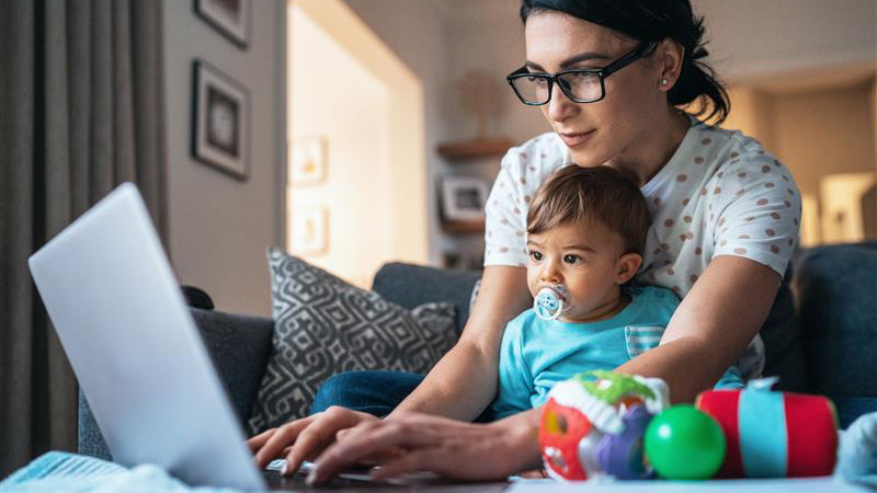 woman with her baby while on a laptop