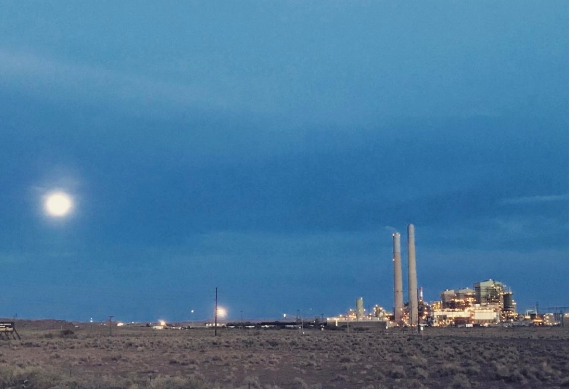 Coal power plant against a dark sky