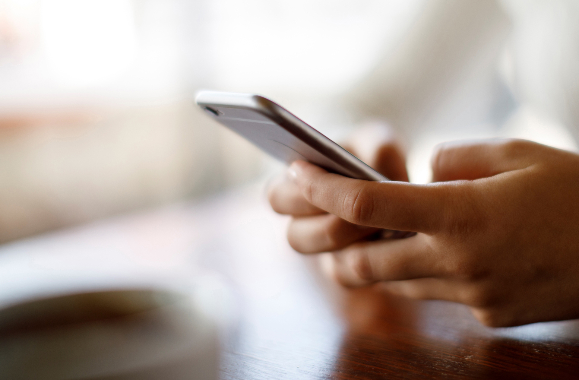 Close up of hands holding a mobile phone