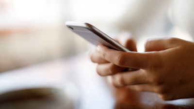 Close up of hands holding a mobile phone