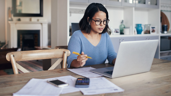 Woman paying bills at a laptop