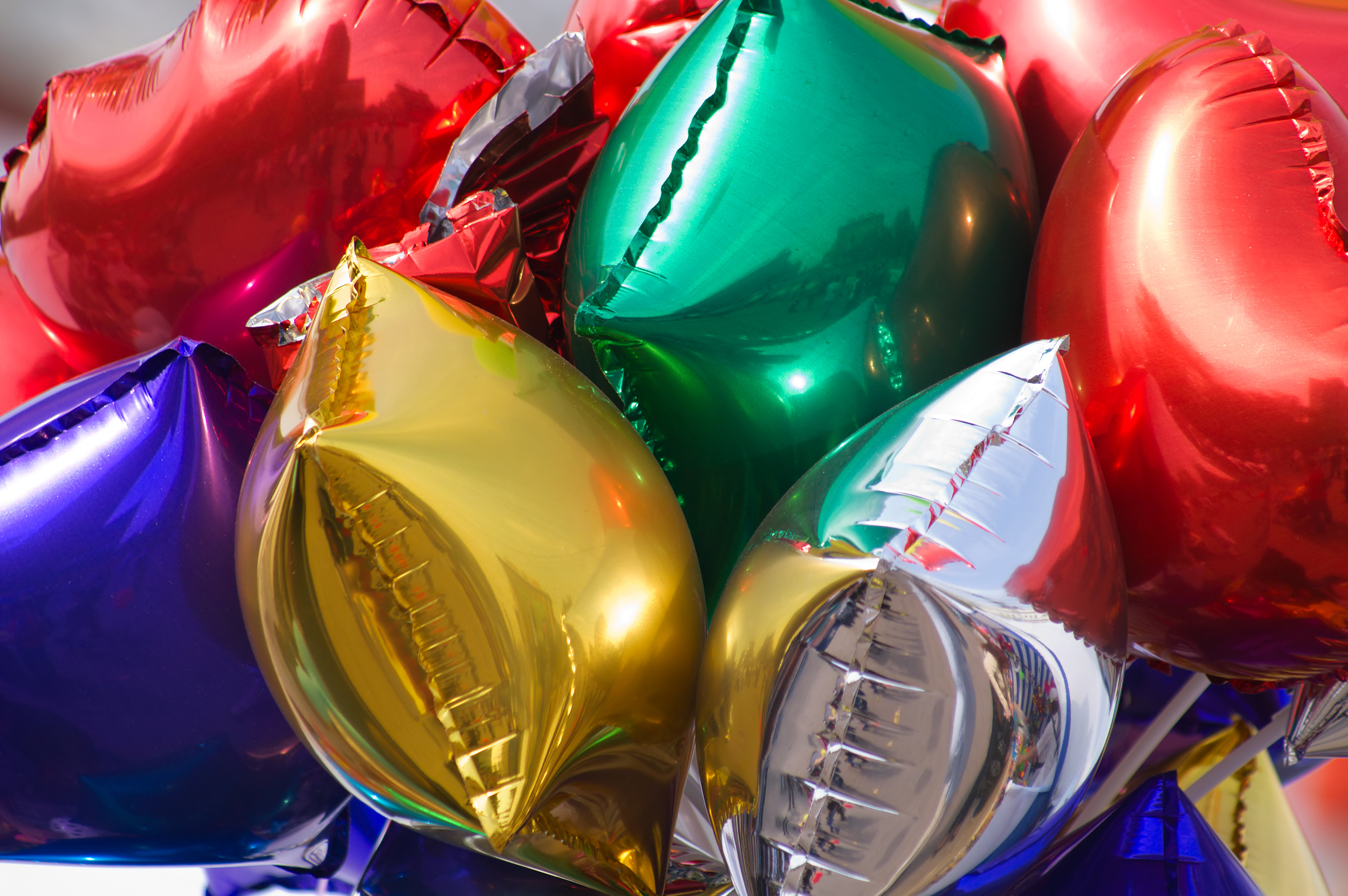 A bunch of colorful mylar balloons