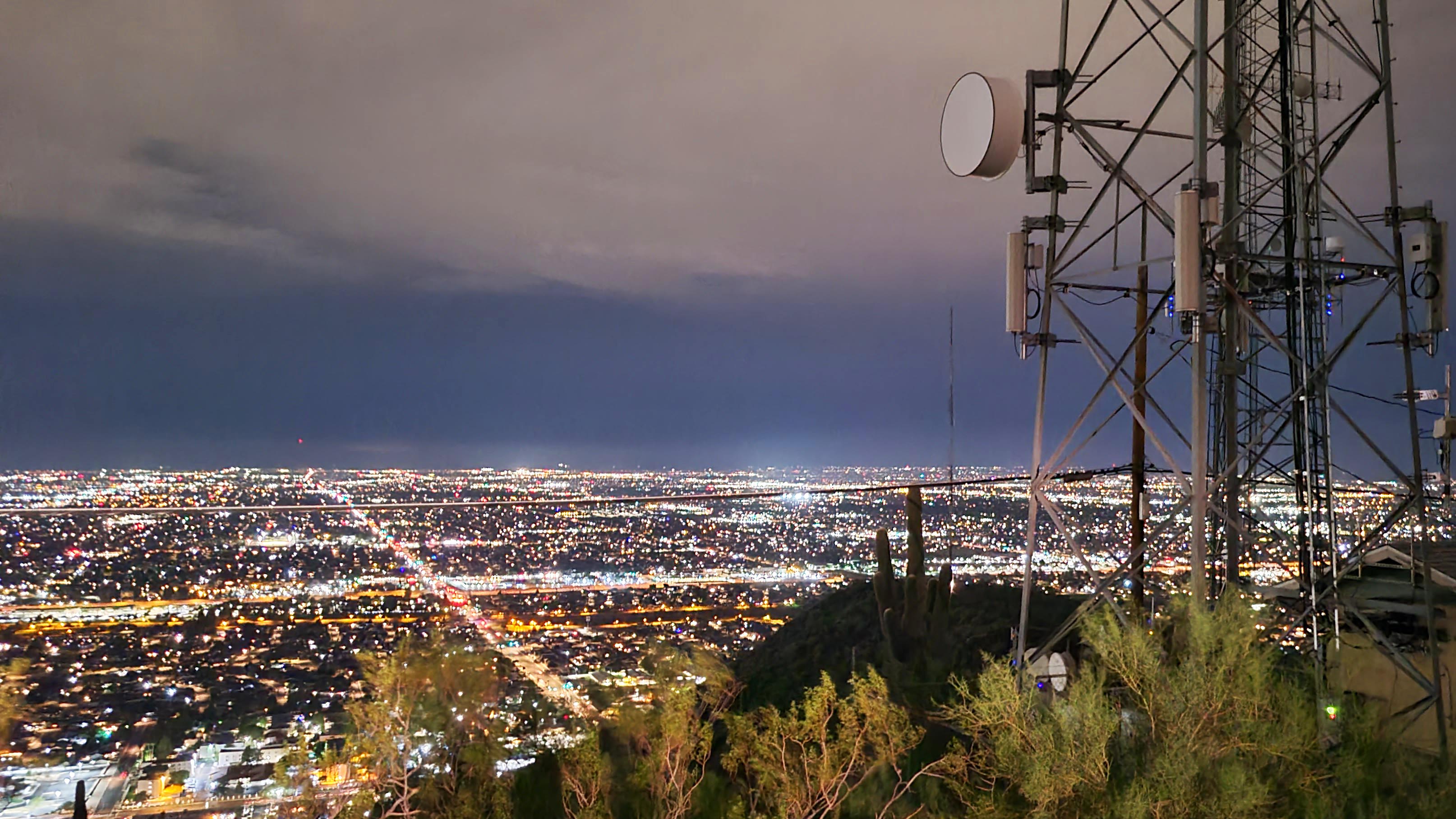 Night time view of the city lights from the top of a mountain