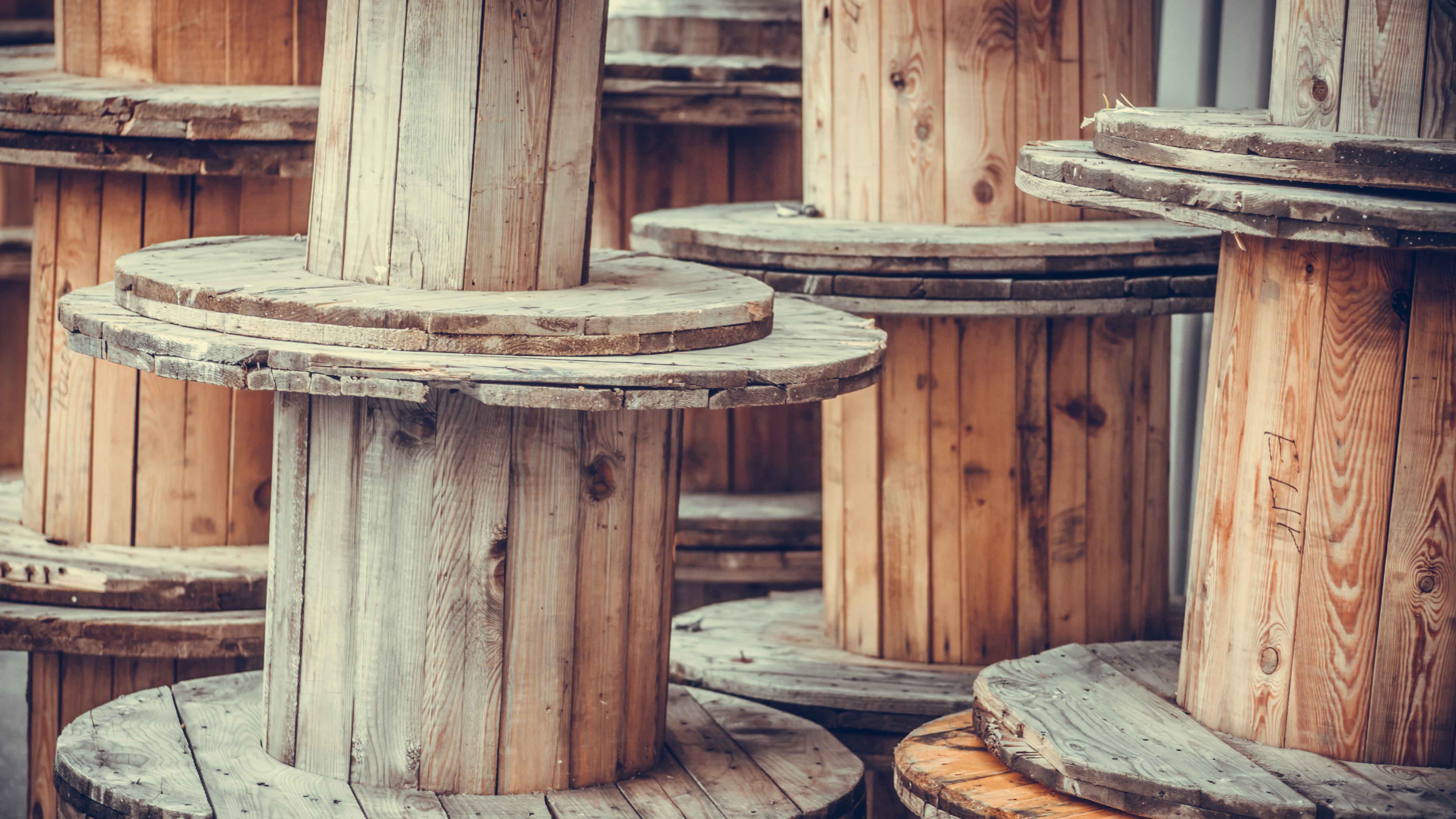 Wooden spools stacked on top of each other.