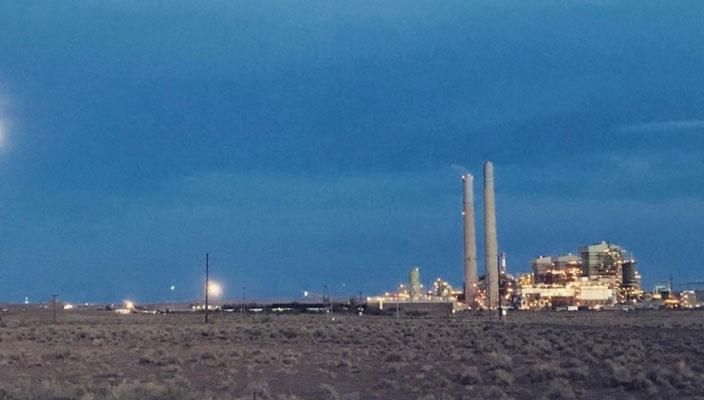 Coal power plant against a cloudy sky