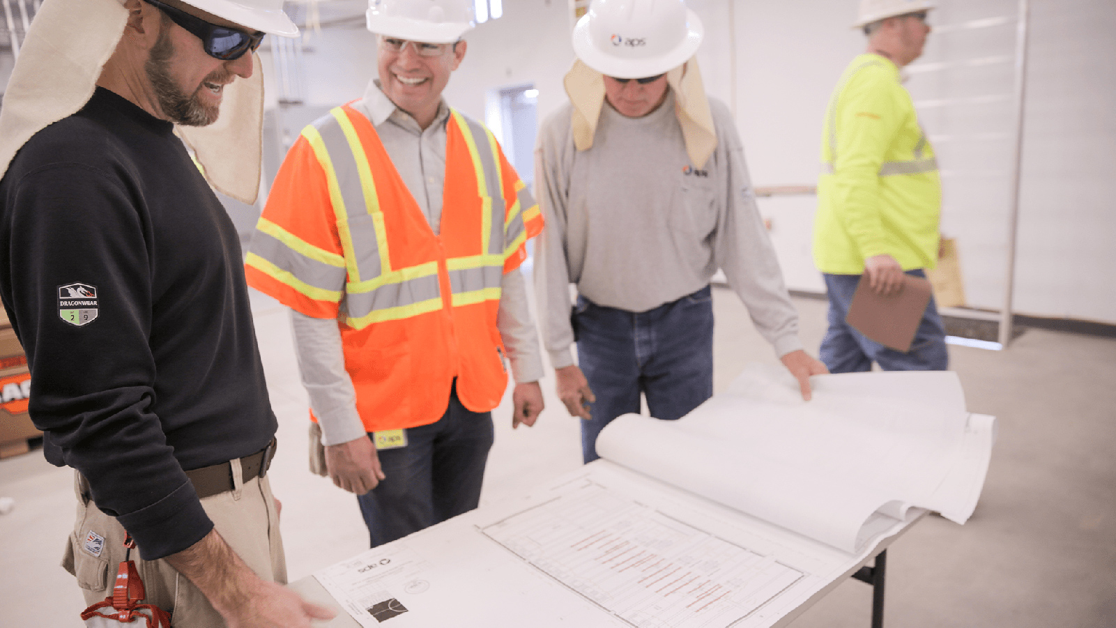 Construction professionals looking at blueprints.