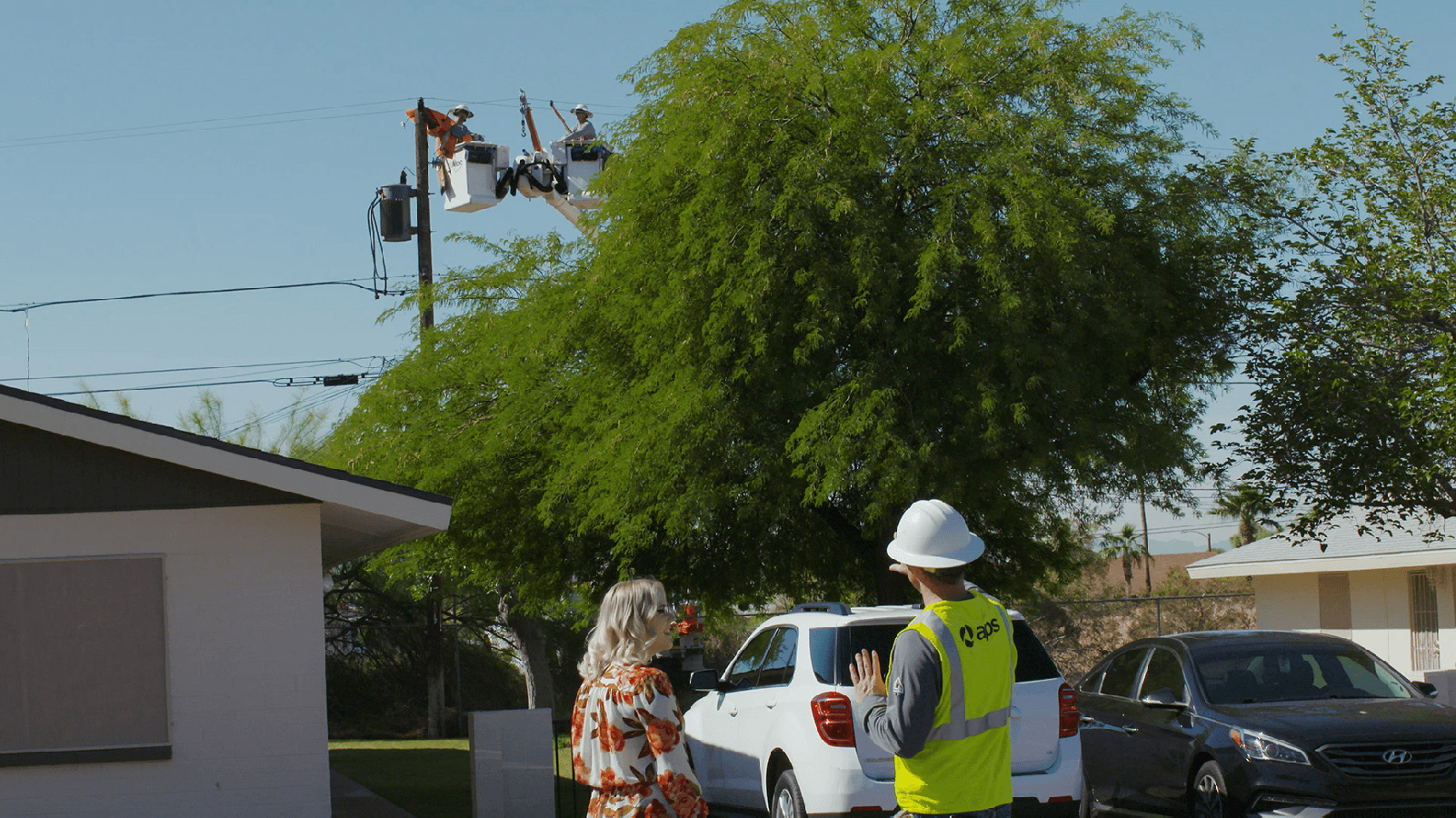 APS employee talking to a customer near homes.