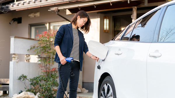 Woman charging her EV