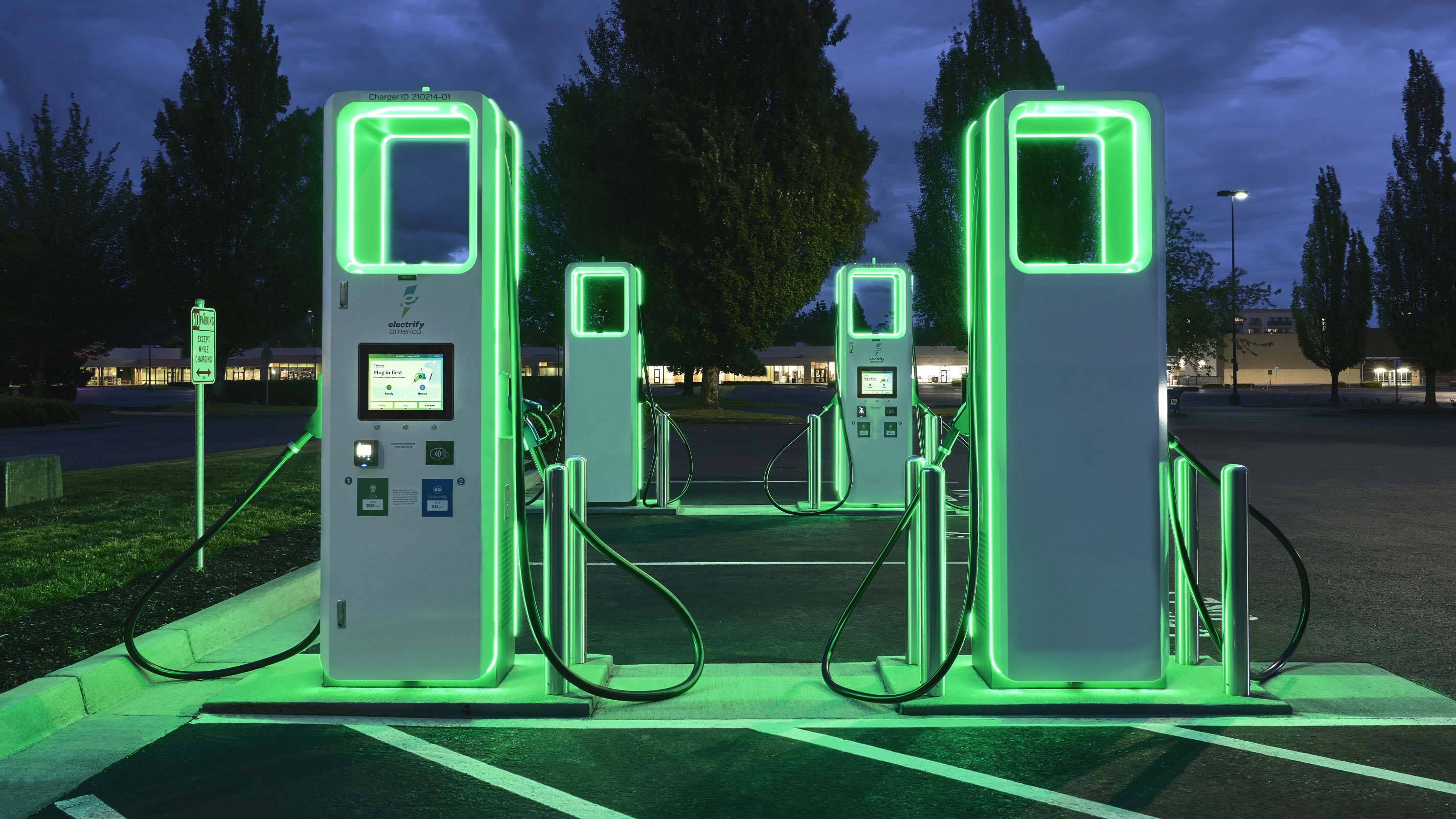 electric vehicle charging stations with neon lights glowing at night