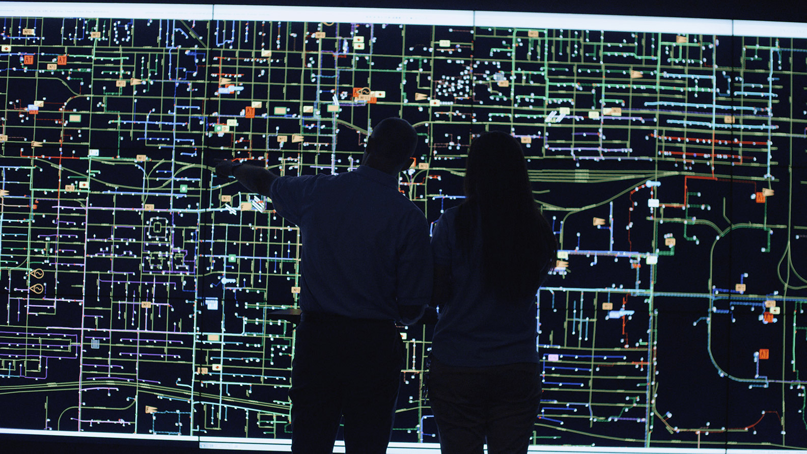 Two people looking a grid map.