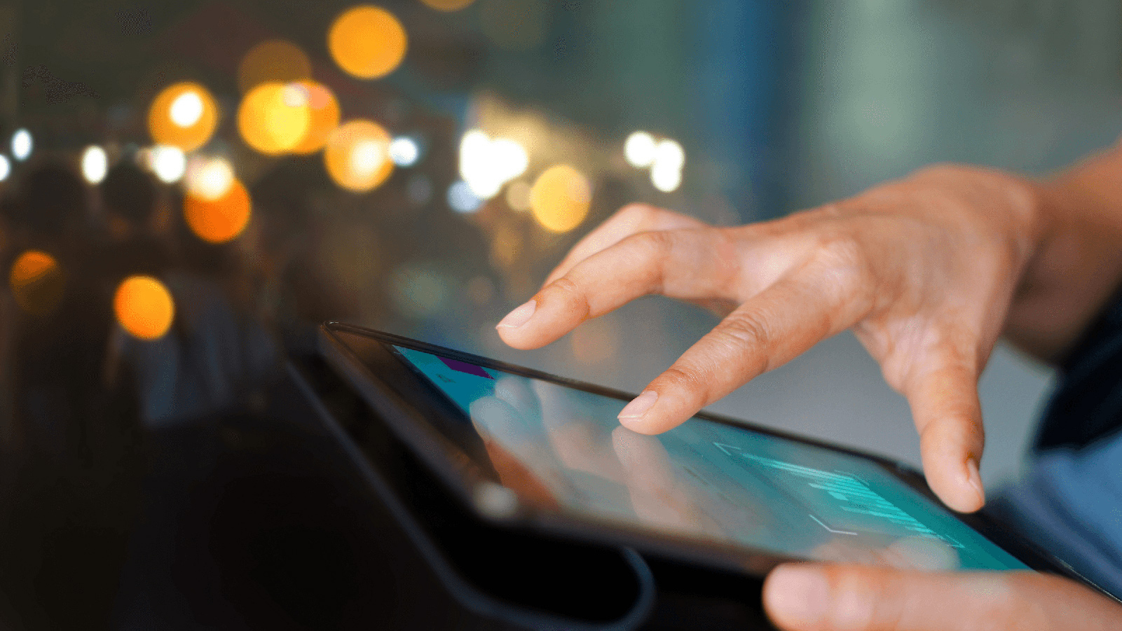 Close up view of someone using a tablet.