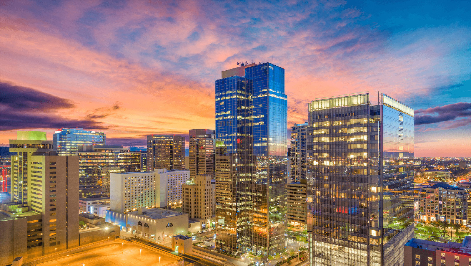 Metro area glass buildings at sunset.