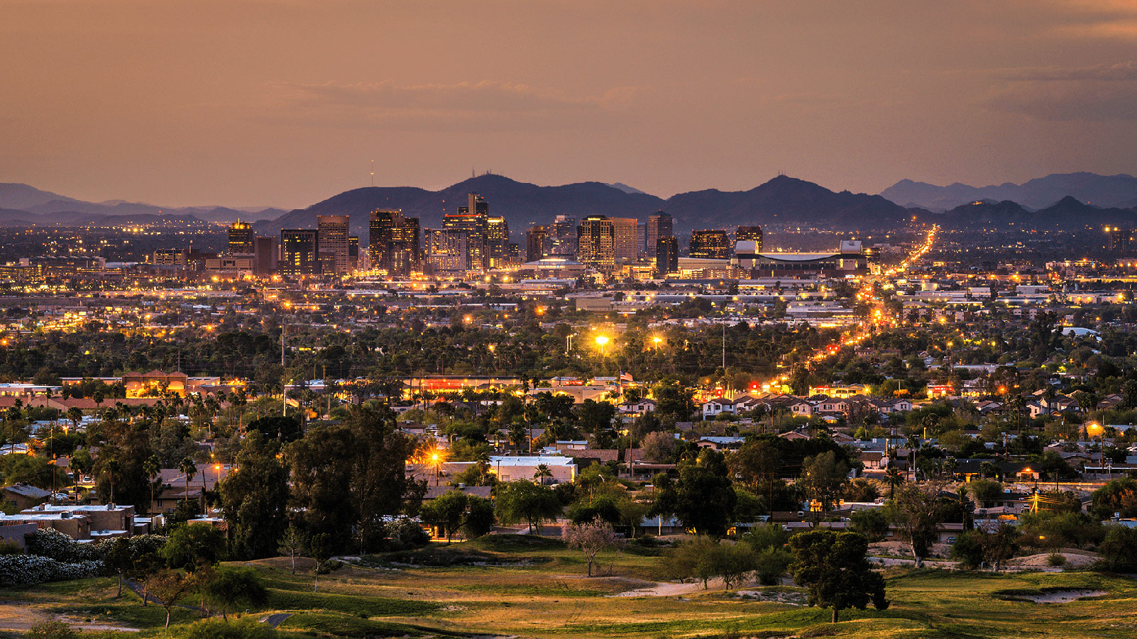 Phoenix metro area at dusk with greenery.