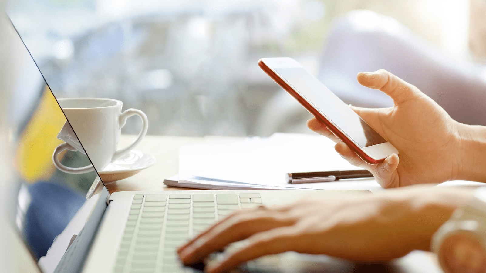 Woman working on her laptop and phone.