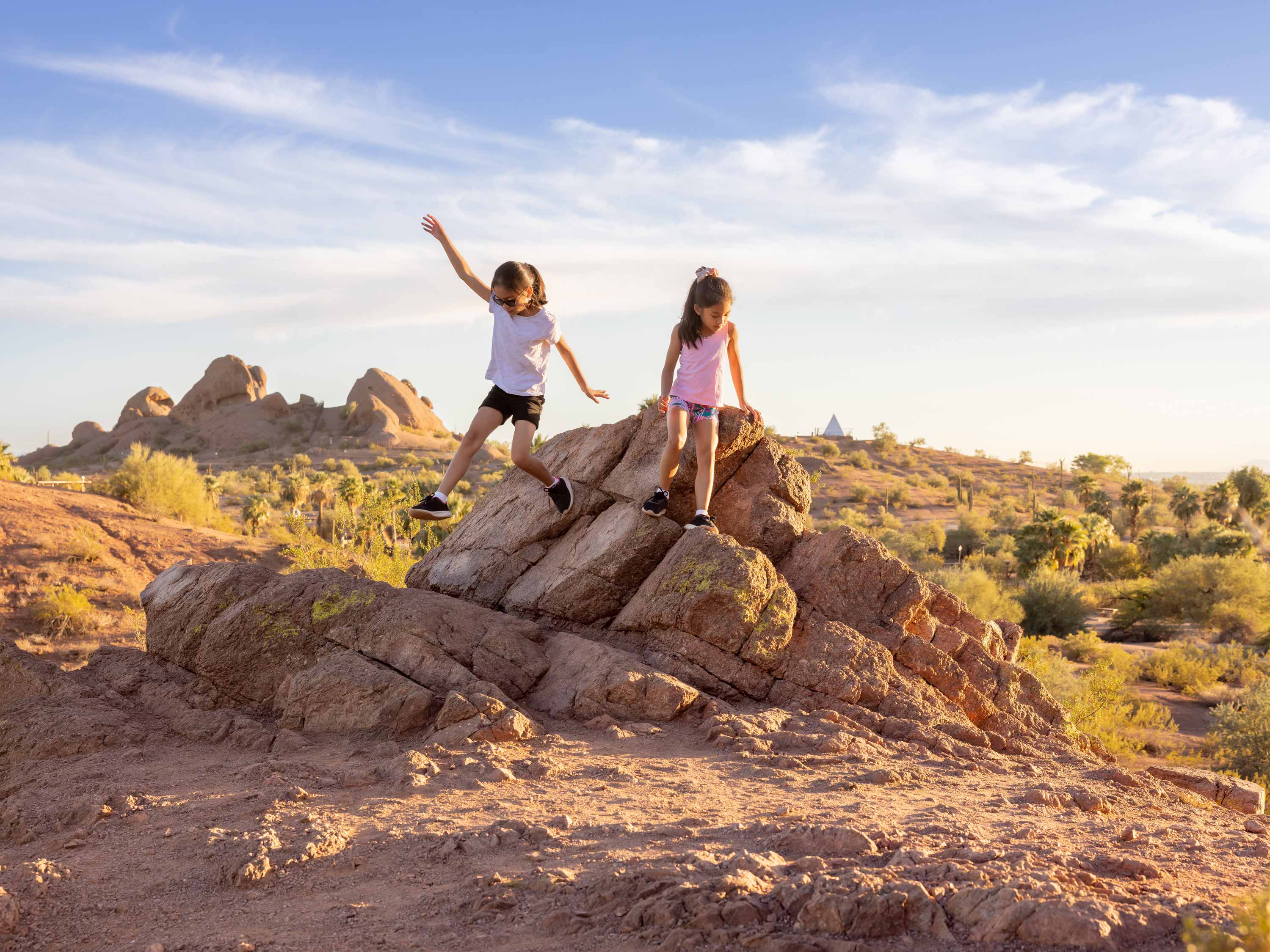 Kids playing on a rock