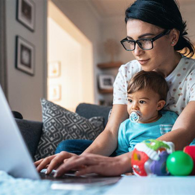 Mom on her laptop with her baby