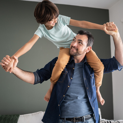 Parent with kid on his shoulders