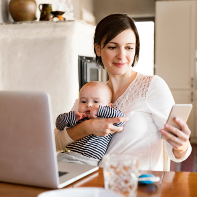 Mom with a baby sitting at her table